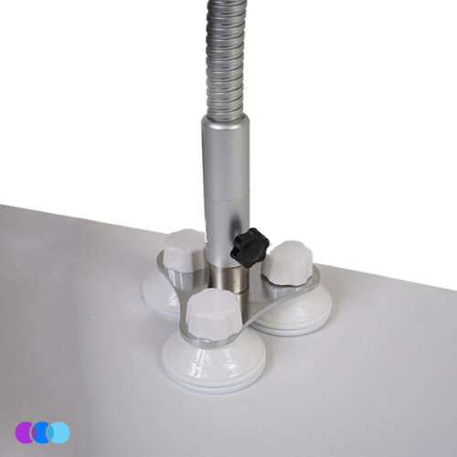 aerovex-sunflower-II-suction-mount-installed A close-up of the Suction Mount option for the Aerovex Sunflower II LED Nail Dust Collector shows its metallic pole secured to a white desk with three suction cups, featuring a tightening knob. Three colored circles are in the bottom left corner. Read more at Aerovex Systems (aerovexsystems.com)