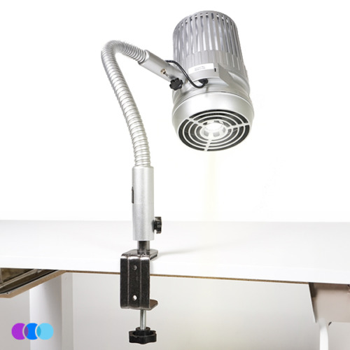 aerovex-sunflower-II-light-on-desk-clamp-installed-full-view A silver, adjustable Aerovex Sunflower II LED Nail Dust Collector is clamped to the edge of a white desk. Three overlapping colored circles appear in the lower left corner. Read more at Aerovex Systems (aerovexsystems.com)