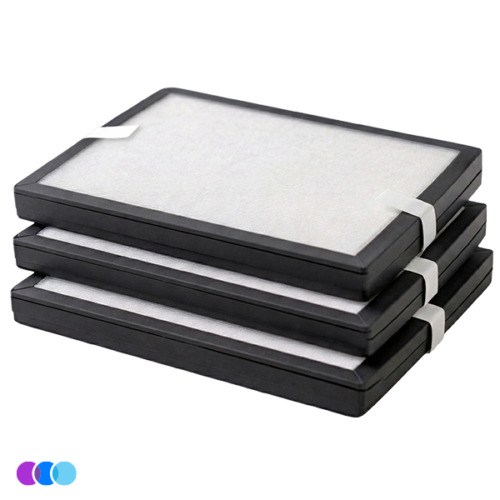 Three rectangular air filters with white centers and black borders are stacked neatly on top of each other for the Filter Multi-Pack for the Aerovex Wall Mounted Air Purifier. Each filter has a white pull tab on one side for handling. The background is plain white, and three colored dots appear in the bottom left corner. Read more at Aerovex Systems (aerovexsystems.com)