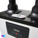 A close-up of an Aerovex Whisper™ salon source capture system with a digital display, buttons, and icons on its front panel. Two vertical pipes extend from the top, and a small remote control with several buttons lies on the flat top surface. Read more at Aerovex Systems (aerovexsystems.com)
