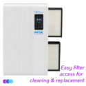 A white Aerovex Max wall mounted air purifier with a digital display on the front, showing two rectangular filters partially removed from its side. Text at the bottom right reads, "Easy filter access for cleaning & replacement" in purple and blue. Read more at Aerovex Systems (aerovexsystems.com)