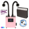 A pink Aerovex WHISPER MiniVent salon source capture system with two flexible black exhaust hoses with LED lights and digital display is shown next to a gray wall-mounted air purifier unit. Icons indicate it meets IMC standards and includes an exhaust hose that vents to the outside. Read more at Aerovex Systems (aerovexsystems.com)