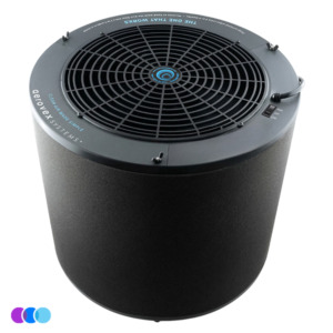 The One That Works Salon Room Air Purifier is a sleek, cylindrical black unit with a top-facing circular vent and THE ONE THAT WORKS in blue text near the edge. Three colored circles appear at the bottom left of the image. Read more at Aerovex Systems (aerovexsystems.com)