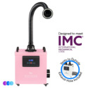 A pink portable Aerovex Systems Whisper MiniVent™ Source Capture System with a flexible black suction hose with led light attached. The front panel displays controls and a digital screen. Text reads “Designed to meet IMC,” “Vents to Outside,” and “Exhaust Hose Included.” Three color circles are at the bottom left. Read more at Aerovex Systems (aerovexsystems.com)